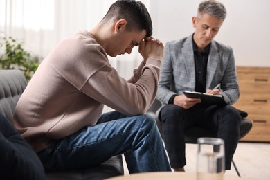 Photo of Professional psychotherapist working with patient in office