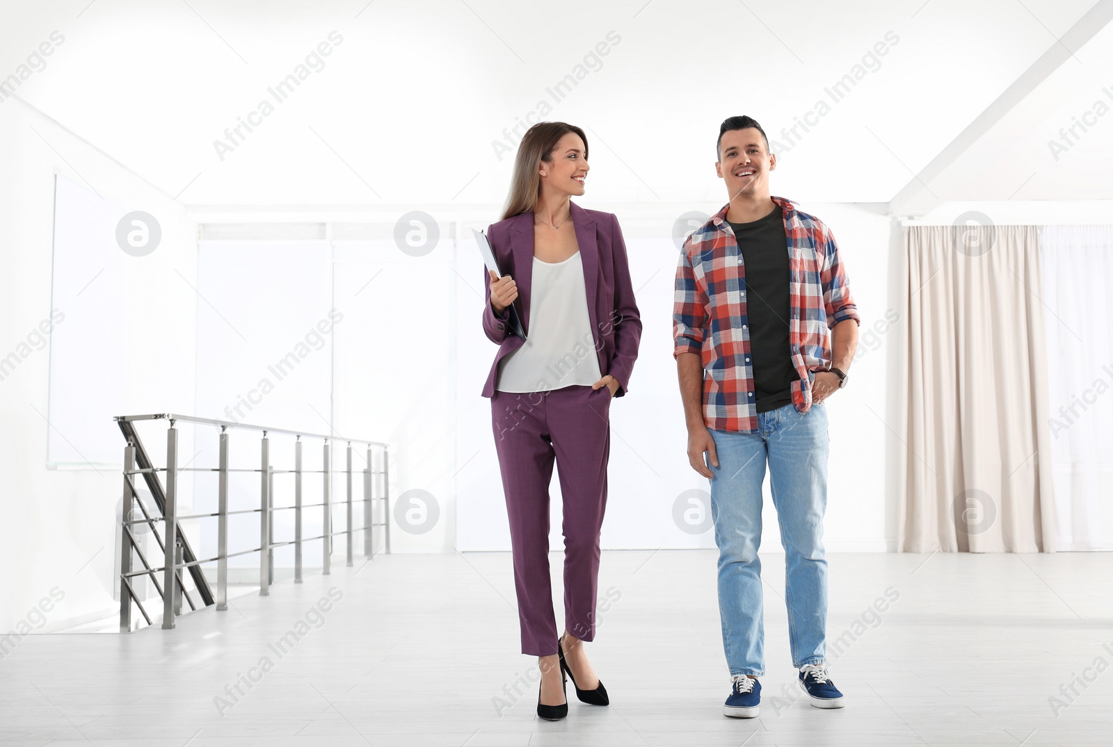 Photo of Real estate agent showing new apartment to client. Space for text