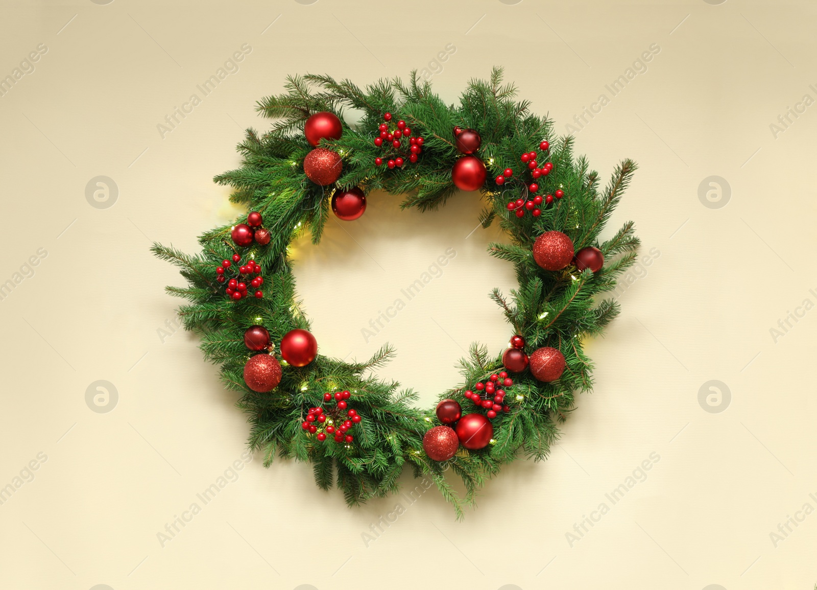 Photo of Beautiful Christmas wreath with festive decor on beige background, top view