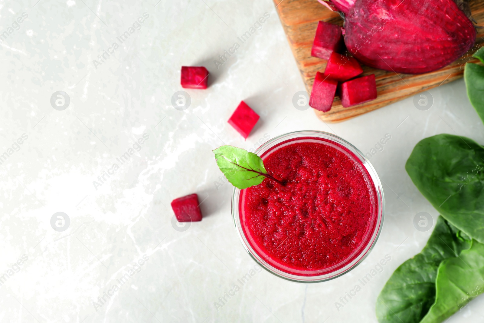 Photo of Glass of fresh beet juice on table, top view