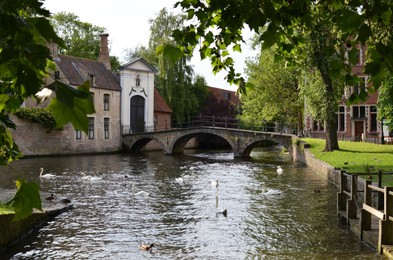 BRUGES, BELGIUM - JUNE 14, 2019: Bridge over canal and entrance gate to the Princely Beguinage Ten Wijngaerde