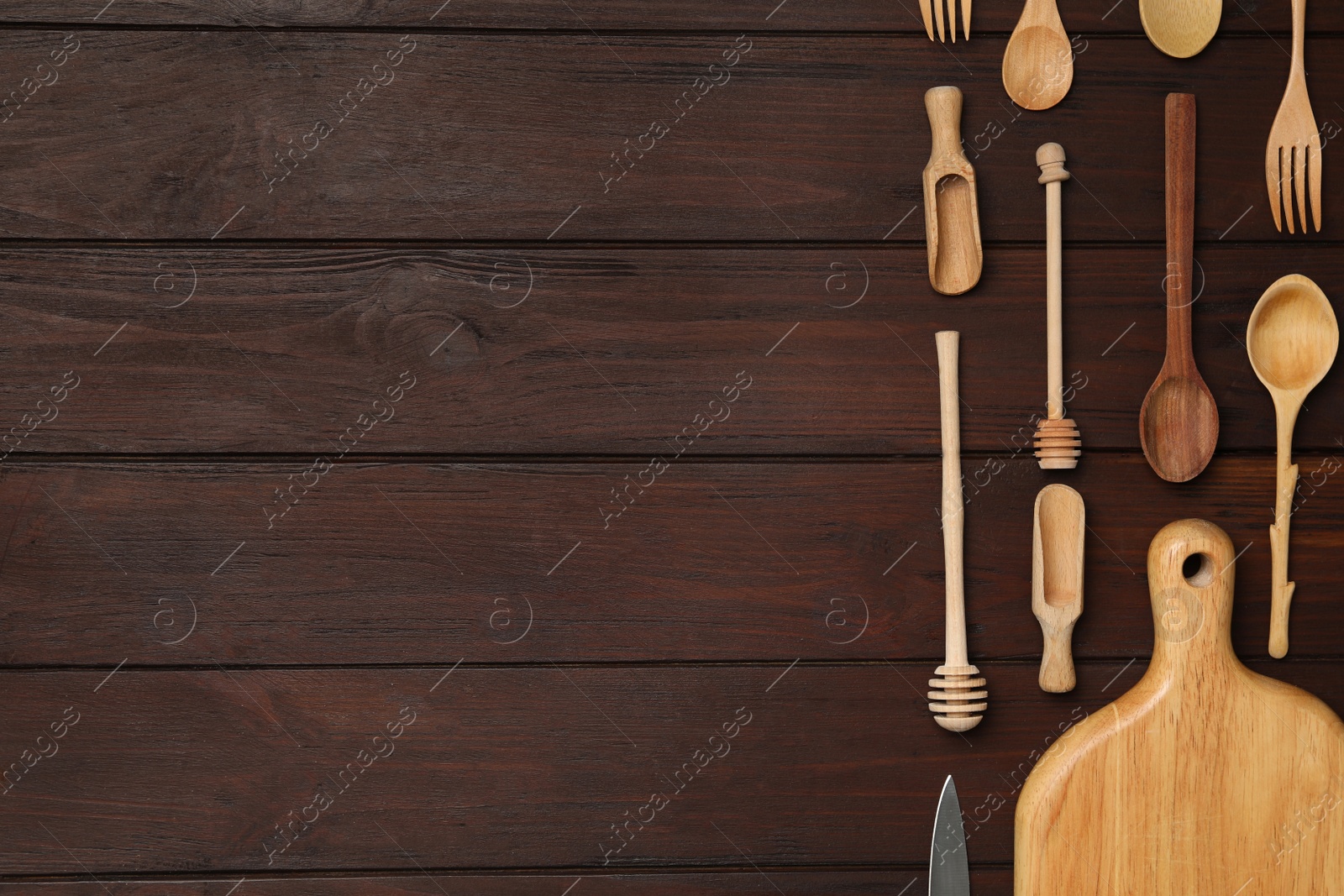 Photo of Set of modern cooking utensils on brown wooden table, flat lay. Space for text