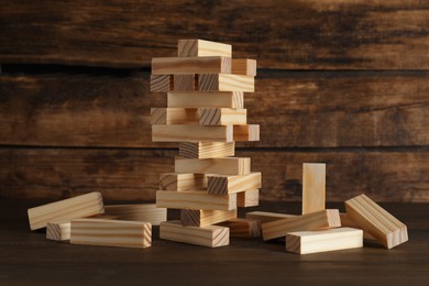 Photo of Jenga tower and wooden blocks on table