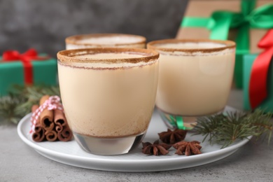 Delicious Christmas liqueur on grey table, closeup