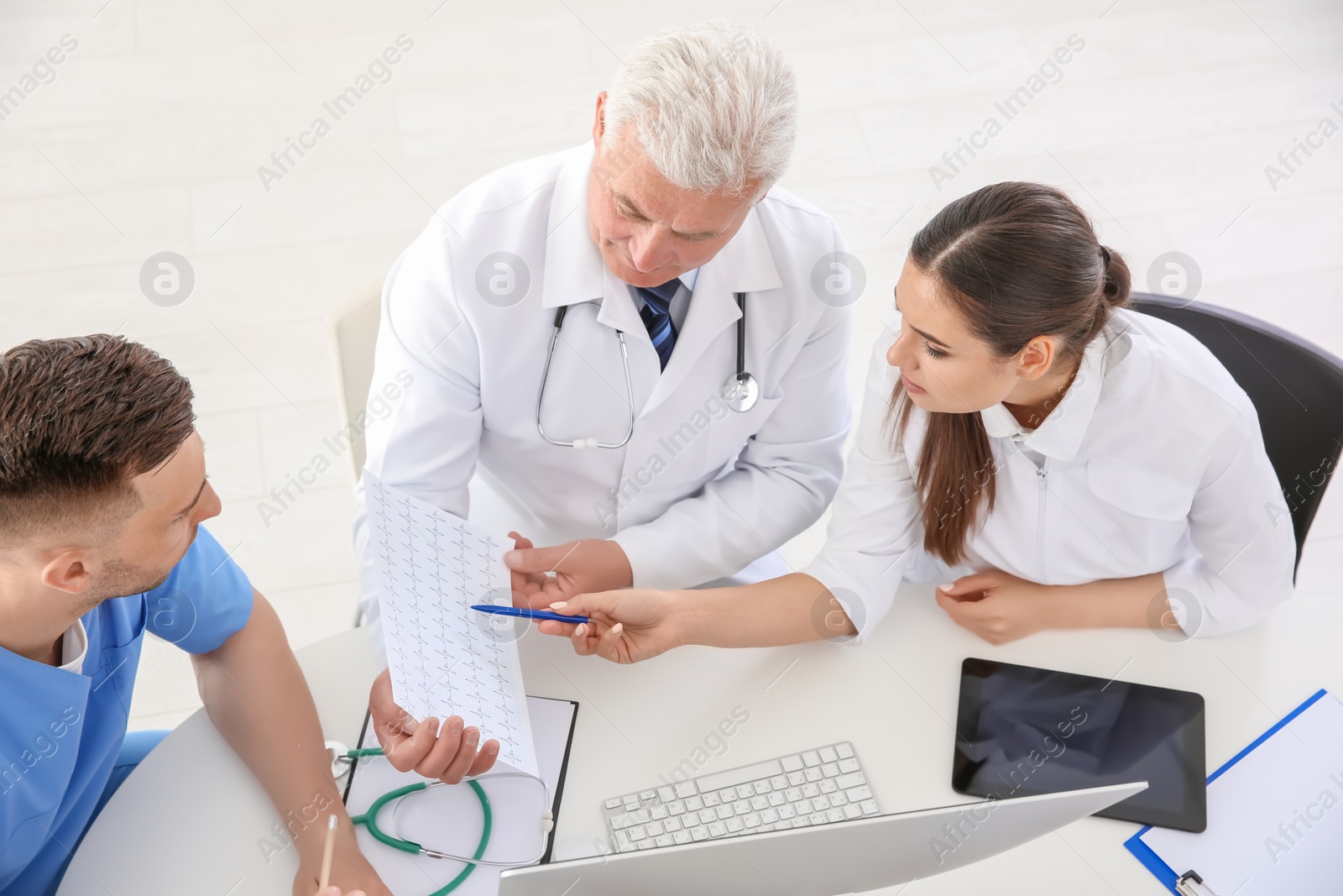 Photo of Group of doctors attending meeting in clinic. Cardiology conference