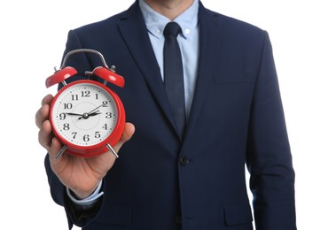 Businessman holding alarm clock on white background, closeup. Time management