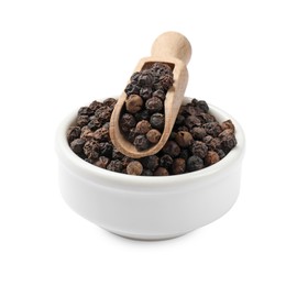 Photo of Aromatic spice. Many black peppercorns in bowl and scoop isolated on white