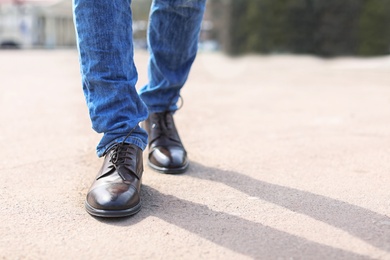 Photo of Man in elegant leather shoes outdoors, closeup