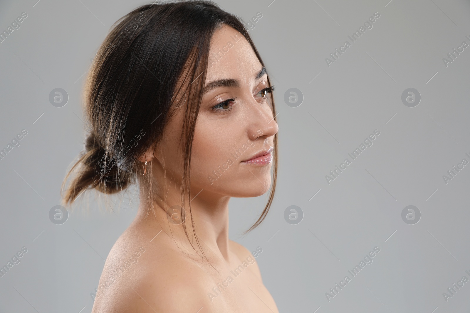 Photo of Portrait of beautiful woman on grey background