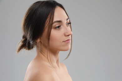 Photo of Portrait of beautiful woman on grey background