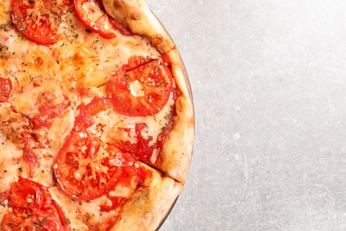 Hot cheese pizza Margherita on grey table, top view. Space for text