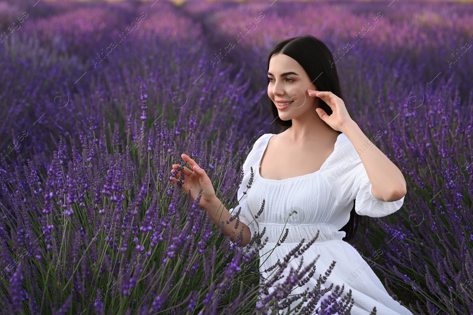 Photo of Portrait of beautiful young woman in lavender field