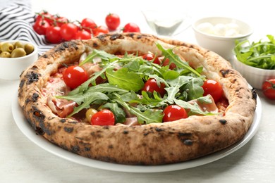 Photo of Tasty pizza with meat and arugula on white table, closeup