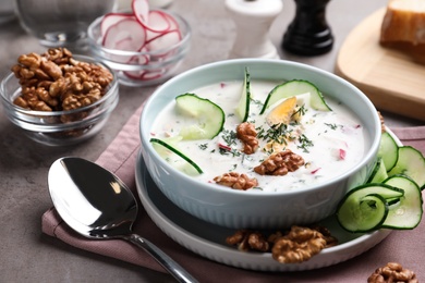 Delicious cold summer soup on grey table