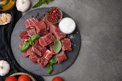 Photo of Flat lay composition with cut fresh beef meat on brown table. Space for text