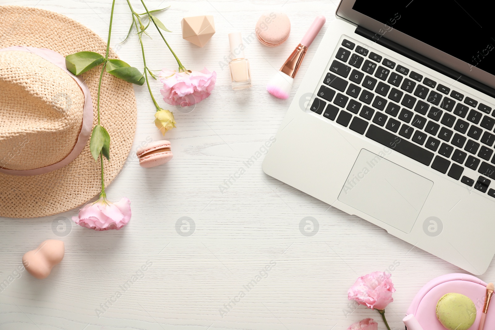 Photo of Flat lay composition with laptop, makeup products and accessories on white wooden table. Fashion blogger