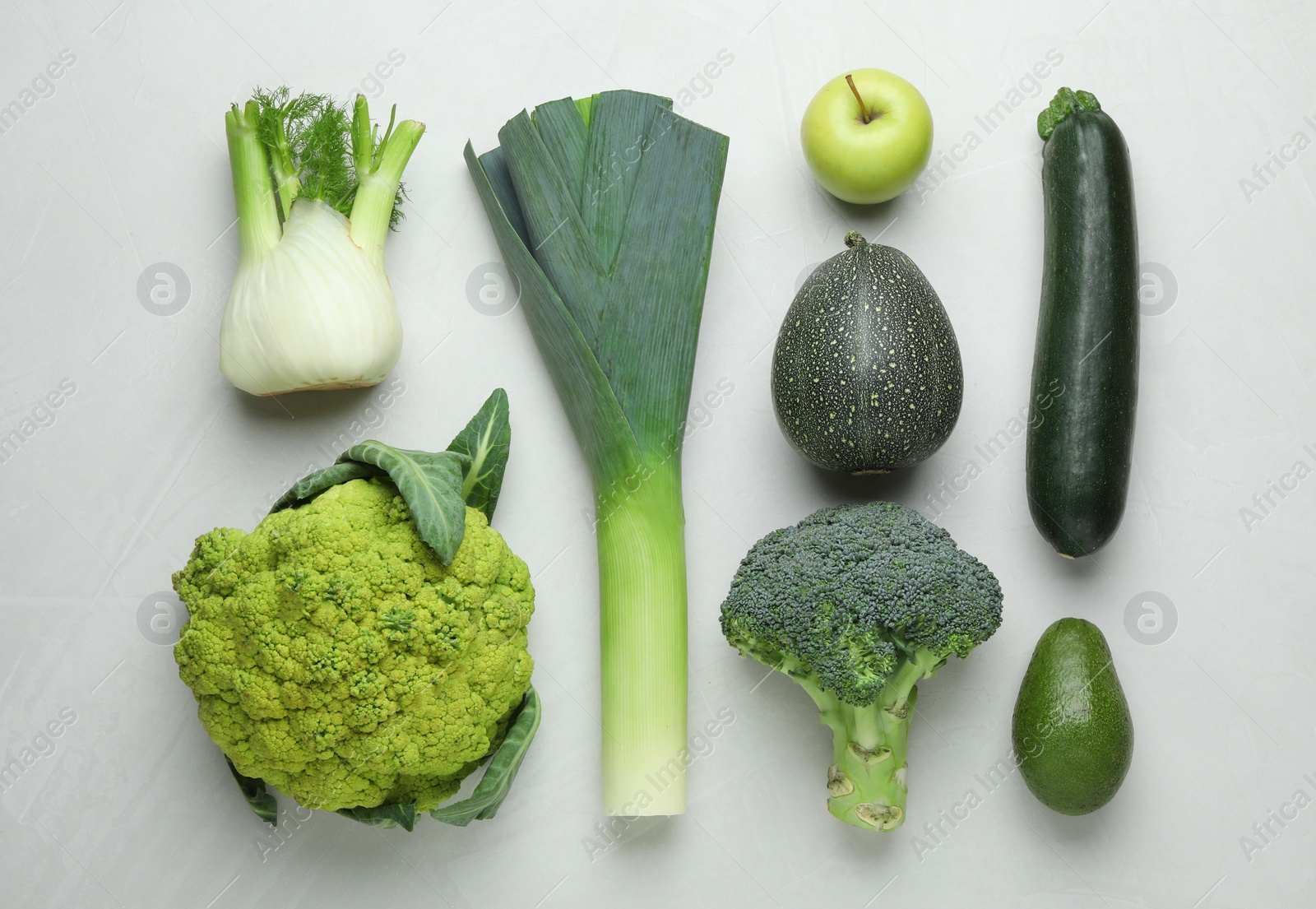 Photo of Flat lay composition with fresh ripe vegetables and fruits on light background