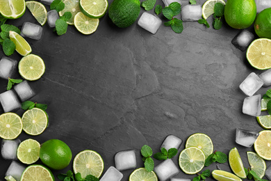 Photo of Frame made of lime slices, mint and ice on black table, top view with space for text. Lemonade layout