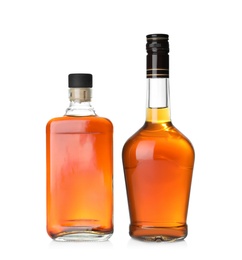 Photo of Bottles of scotch whiskey on white background