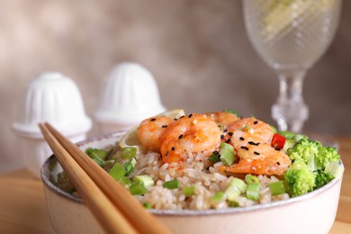 Tasty rice with shrimps and vegetables in bowl, closeup. Space for text