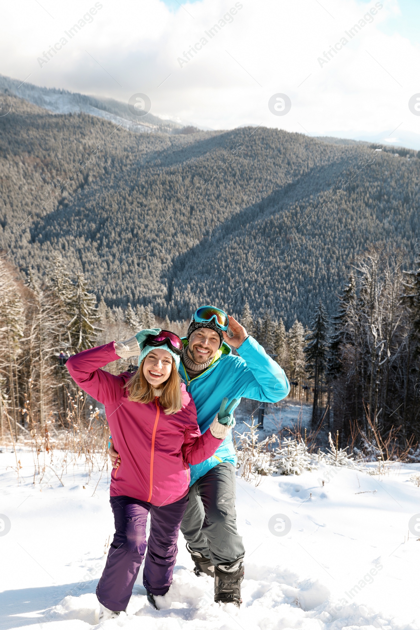 Photo of Happy couple spending winter vacation in mountains. Space for text