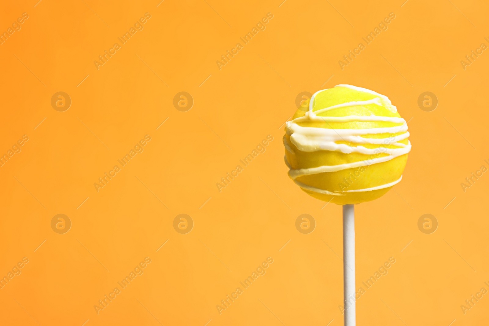 Photo of Bright delicious cake pop on color background. Space for text