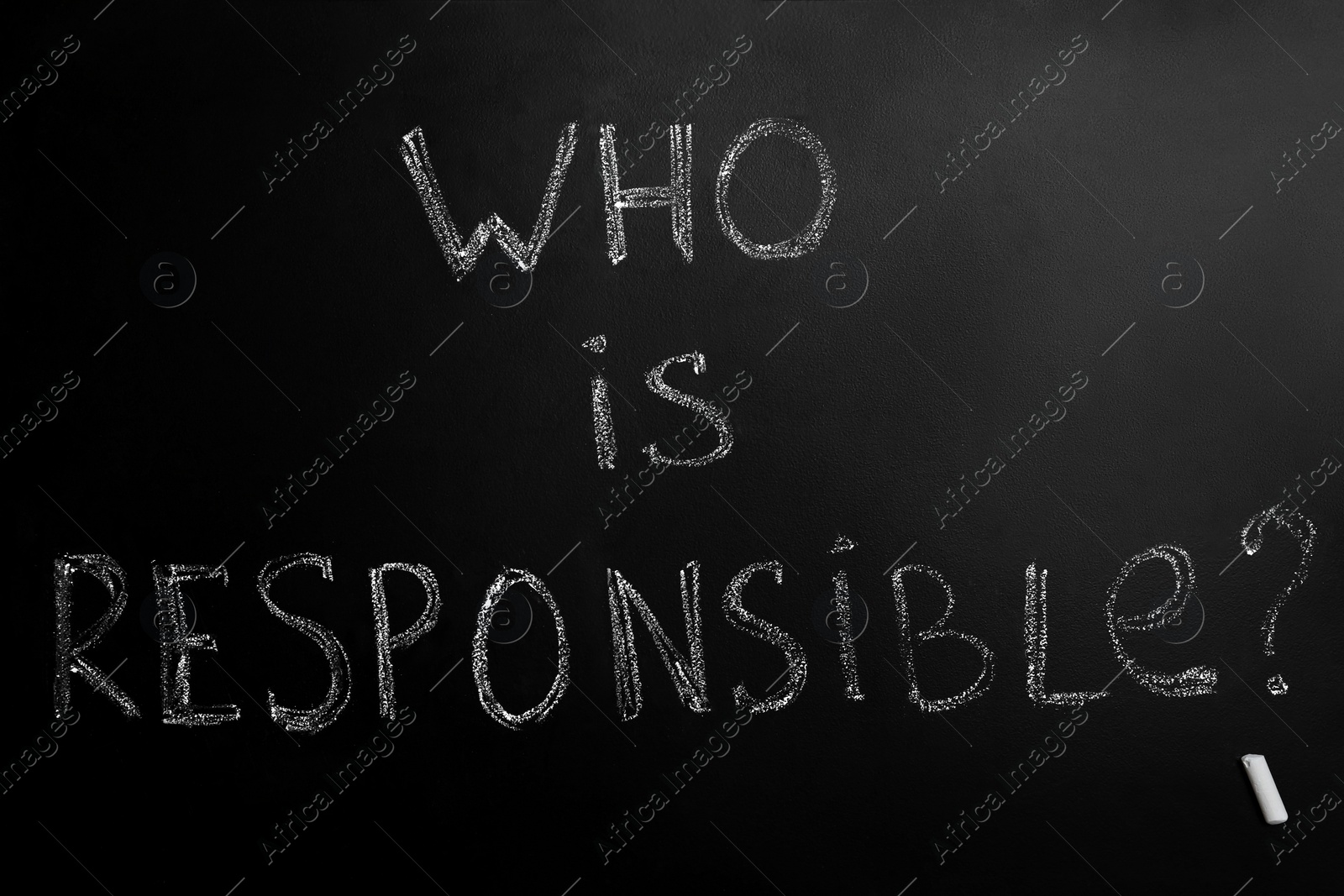 Photo of Question Who Is Responsible and chalk piece on black background