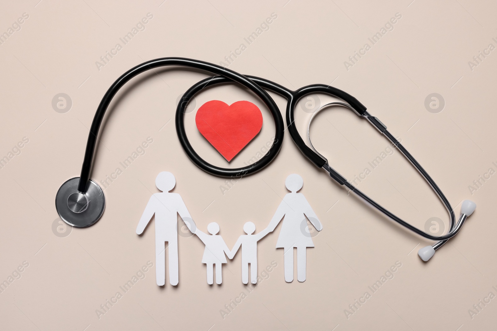 Photo of Paper family figures, red heart and stethoscope on beige background, flat lay. Insurance concept