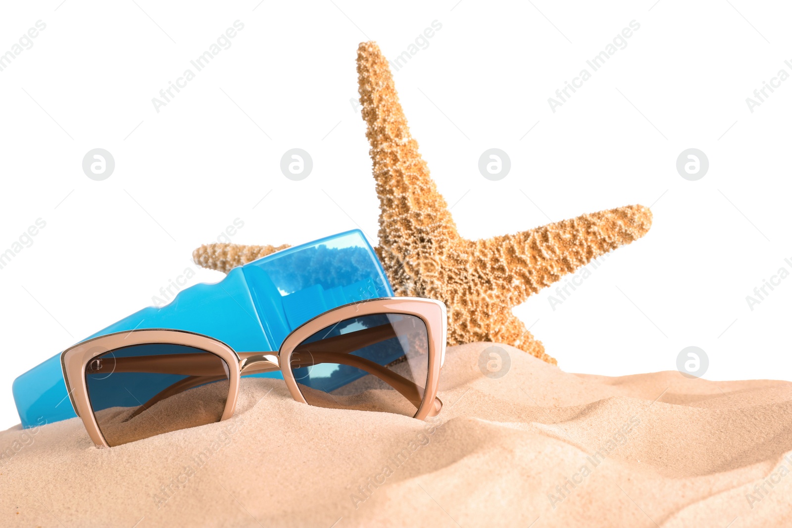 Photo of Beach accessories on sand against white background