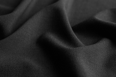 Photo of Texture of dark fabric as background, closeup