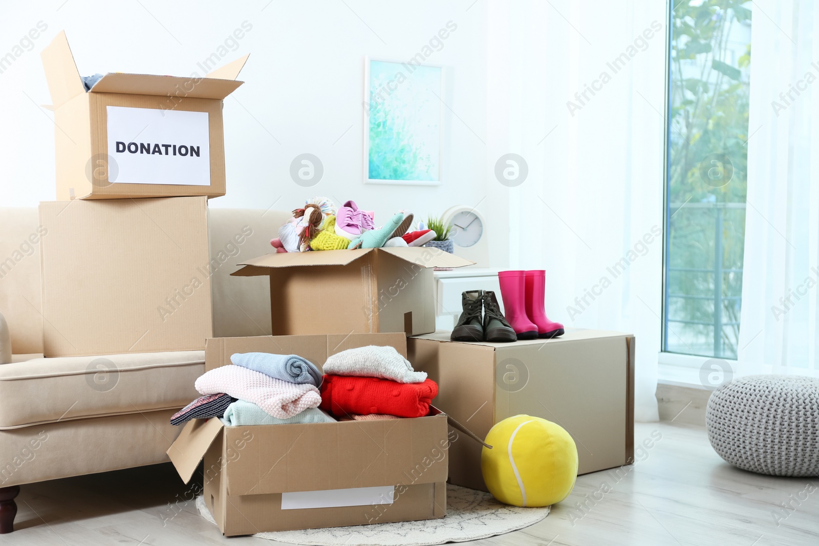 Photo of Carton boxes with donations in living room