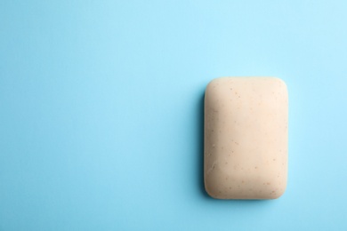 Photo of Soap bar and space for text on color background, top view