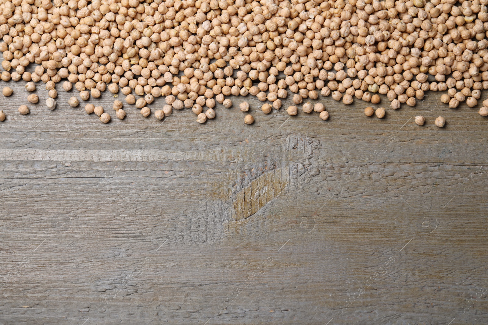 Photo of Chickpeas on wooden table, flat lay. Space for text