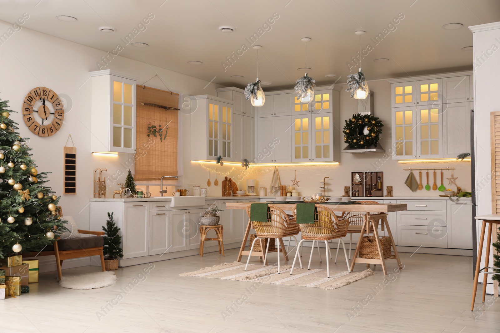 Photo of Cozy open plan kitchen decorated for Christmas. Interior design