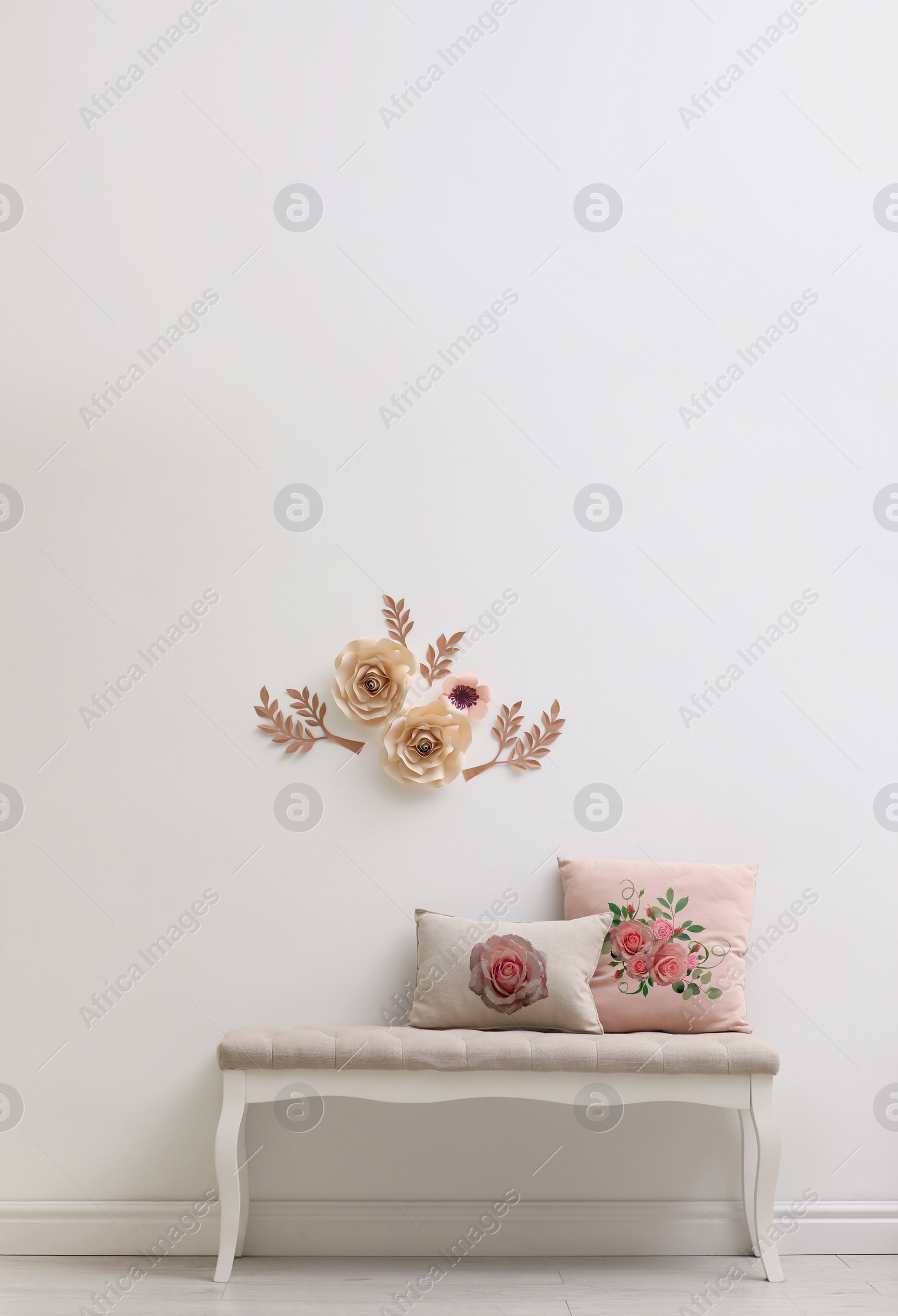 Image of Soft pillows with printed roses on bench indoors