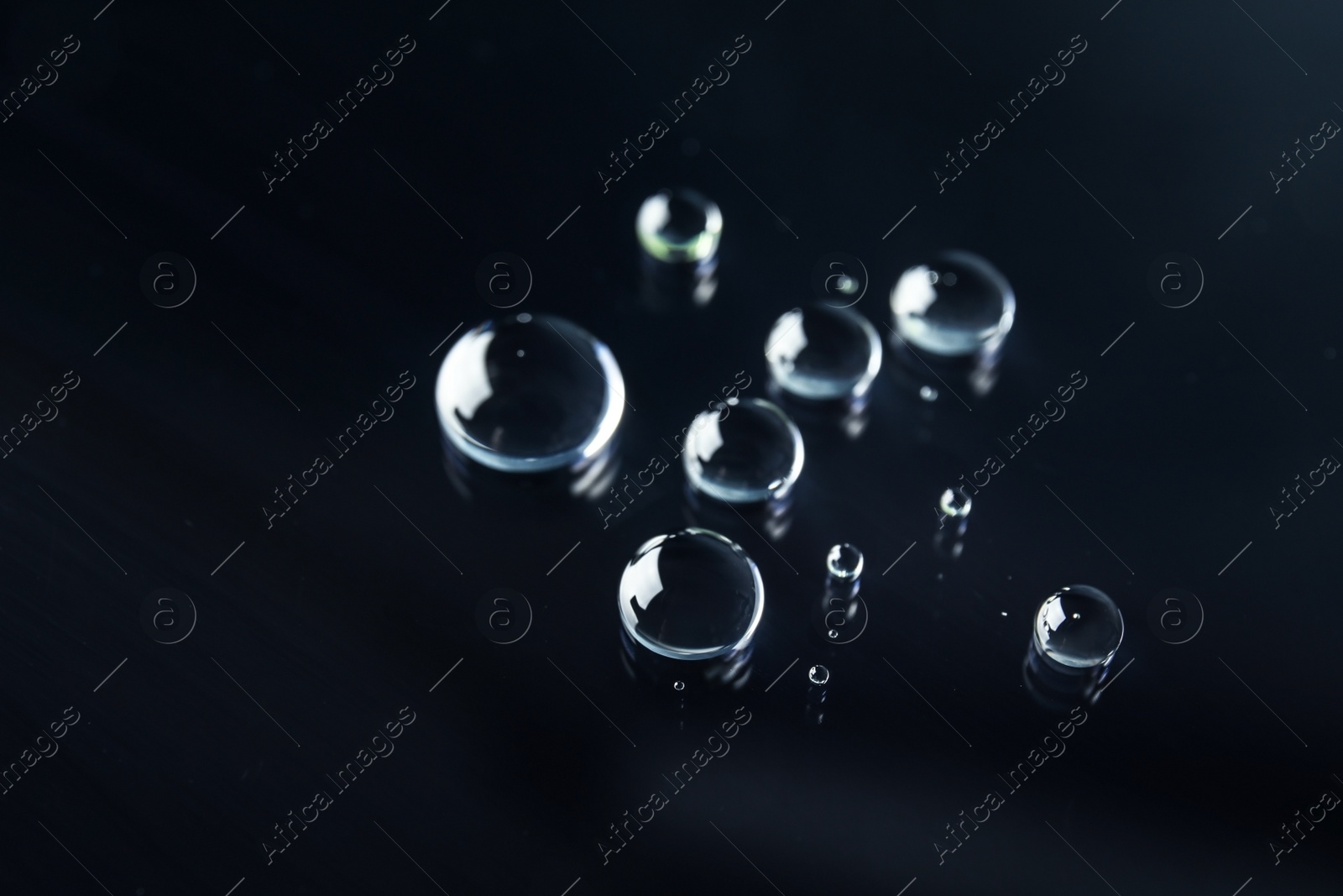 Photo of Many clean water drops on black background