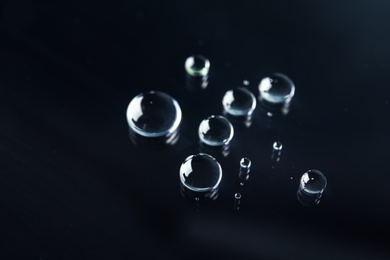 Many clean water drops on black background