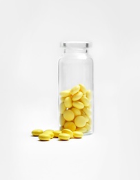 Pills and glass bottle on white background. Medical treatment