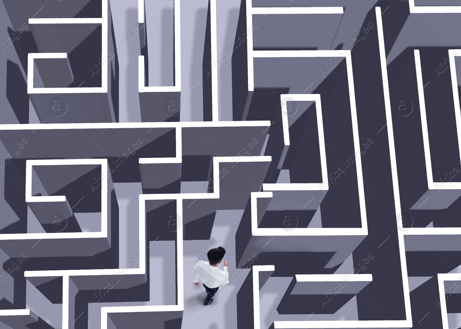 Image of Businessman trying to find way out of maze, above view