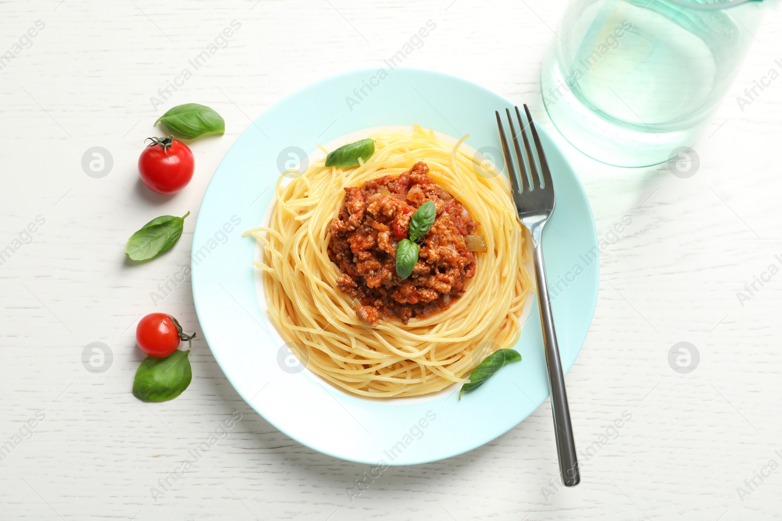 Photo of Flat lay composition with delicious pasta bolognese on light background