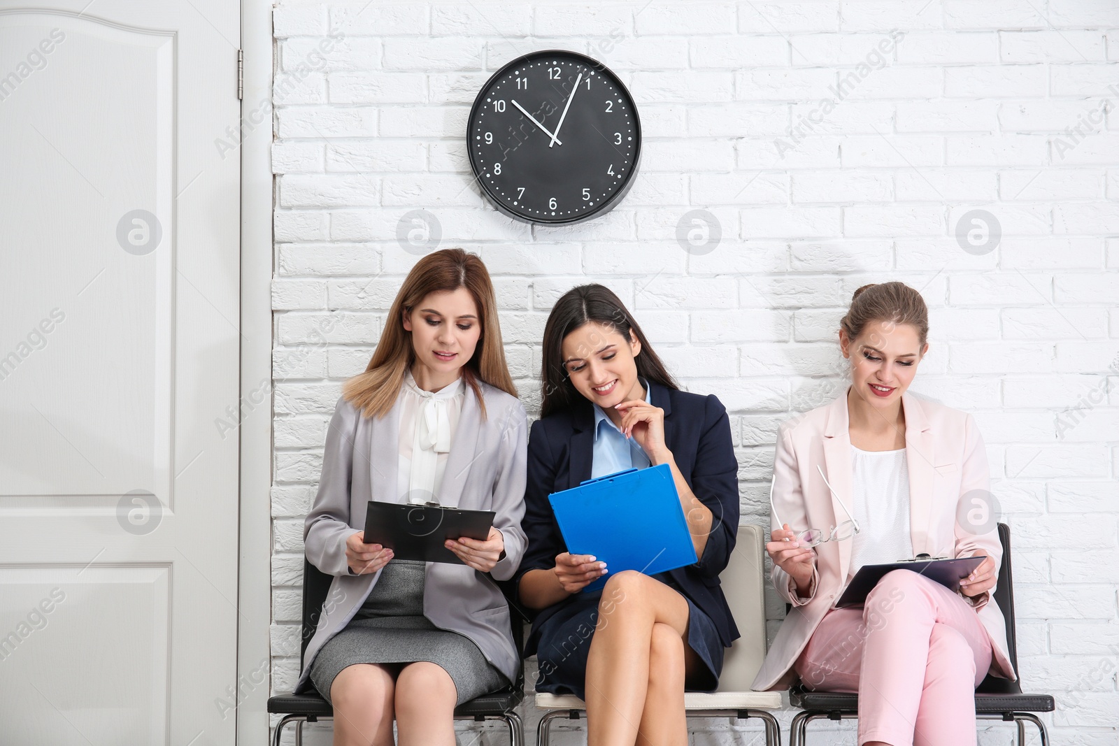 Photo of Young women waiting for job interview, indoors