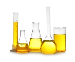 Photo of Laboratory glassware with yellow liquid on white background