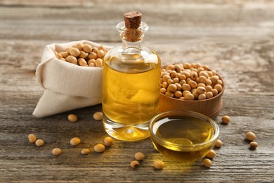 Photo of Composition with soybean oil on wooden table