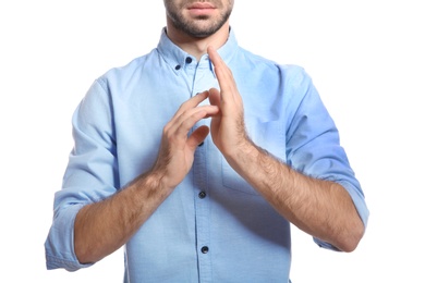 Photo of Man showing JESUS in sign language on white background, closeup