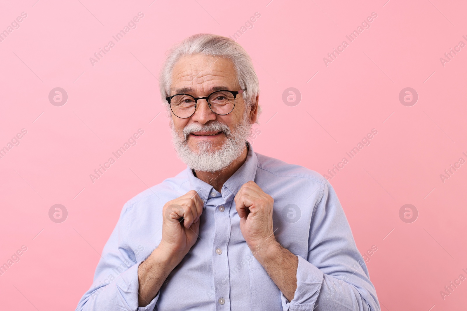 Photo of Portrait of stylish grandpa with glasses on pink background