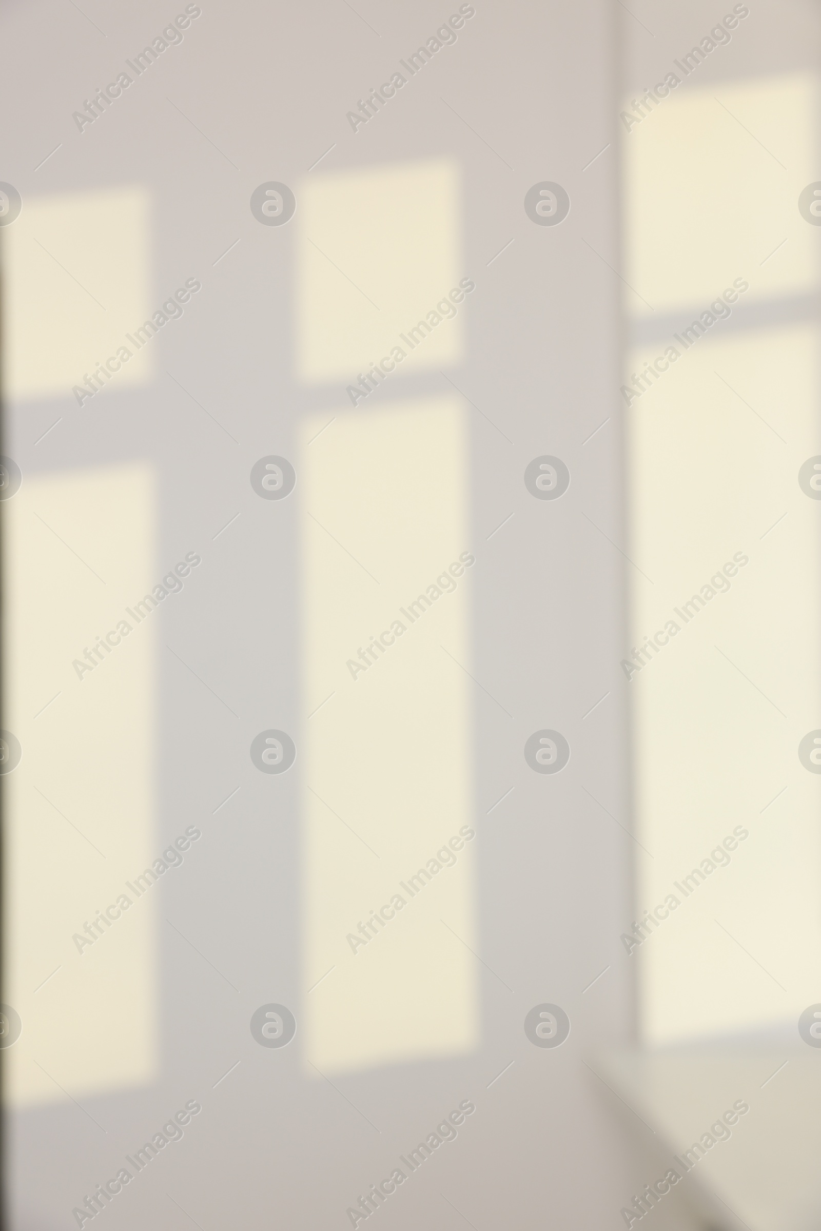 Photo of Blurred view of light and shadows from window on wall indoors