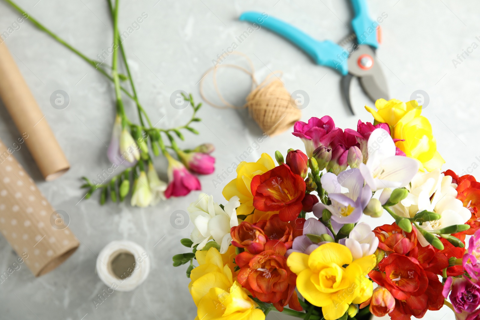 Photo of Flat lay composition with freesia flowers on table