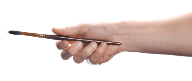 Photo of Man holding paint brush on white background, closeup