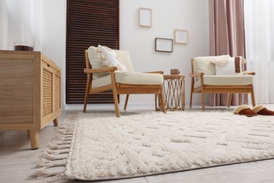 Stylish living room with soft white carpet and furniture, low angle view. Interior design