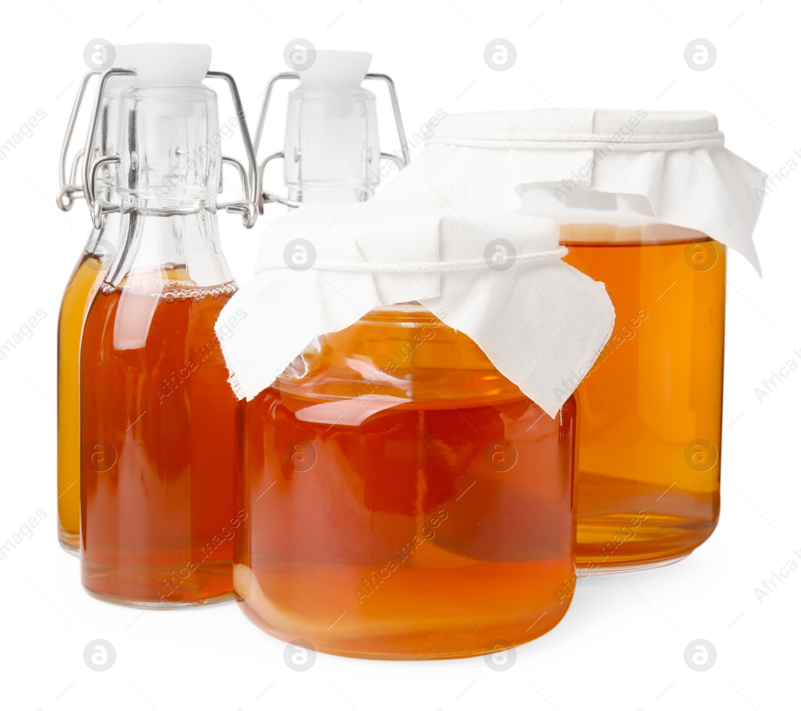 Photo of Tasty kombucha in glass jars and bottles isolated on white